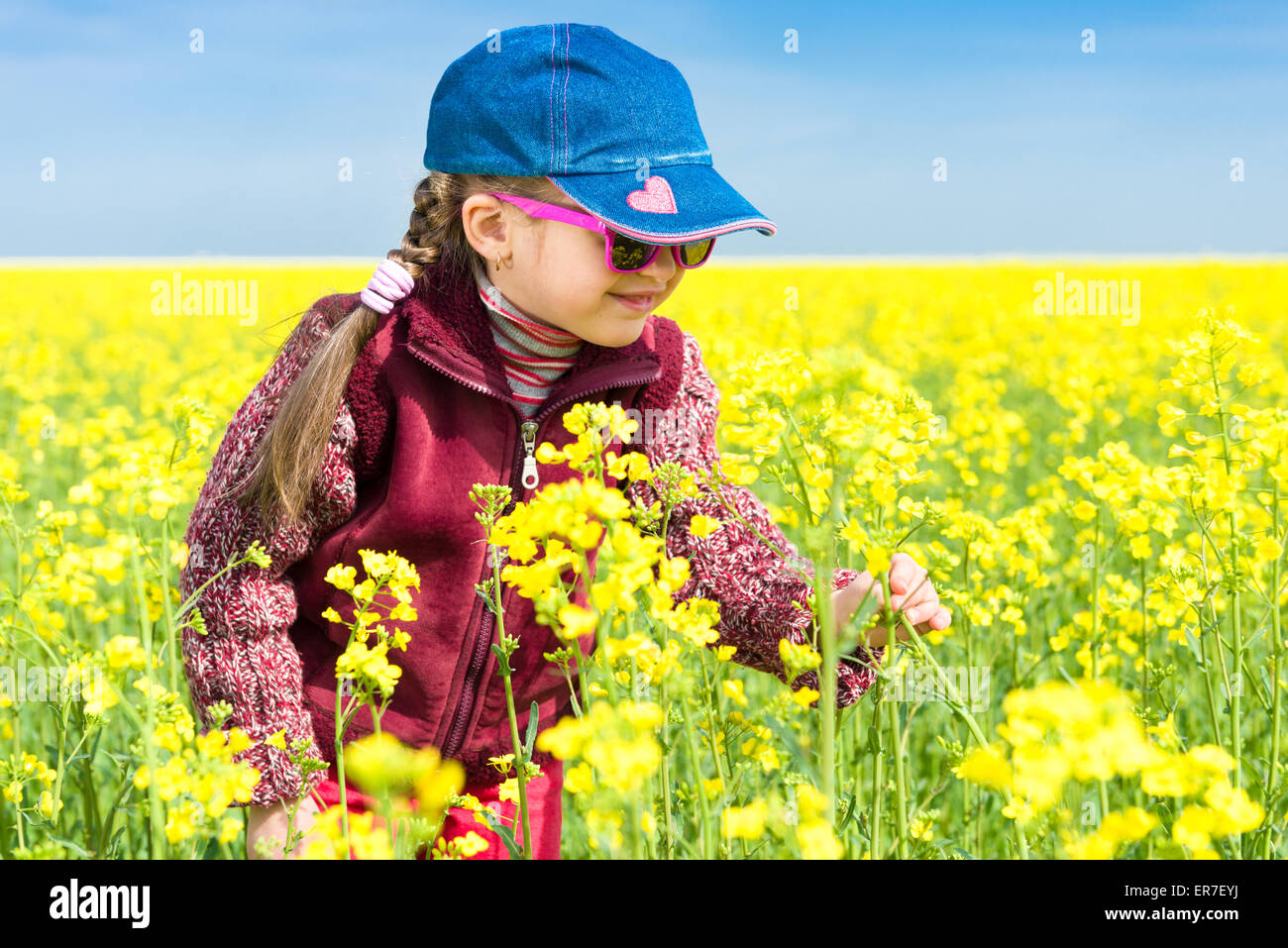 girl in a yellow field of rape Stock Photo - Alamy