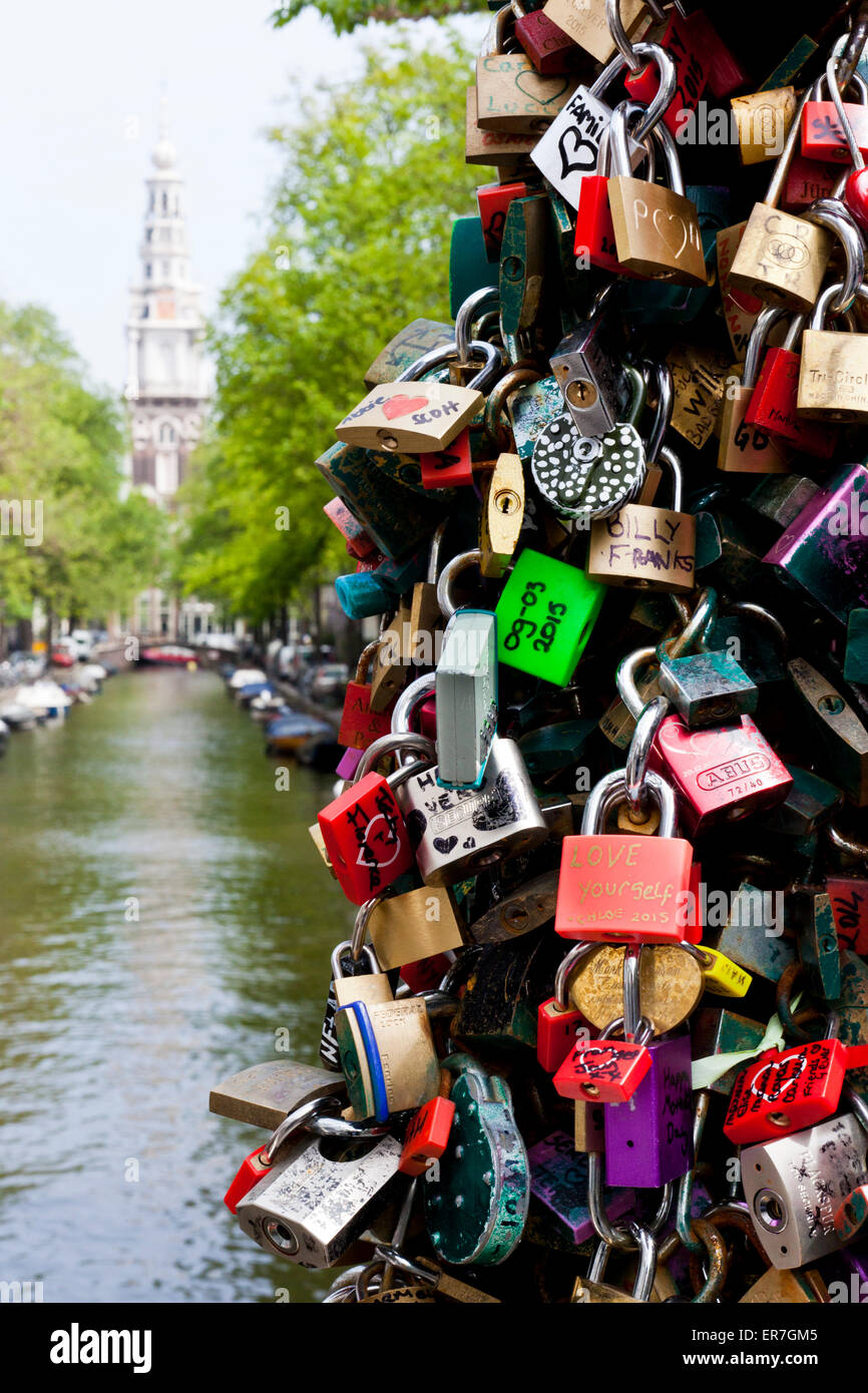 Love padlocks on the bridge over canal Kloveniersburgwal Amsterdam