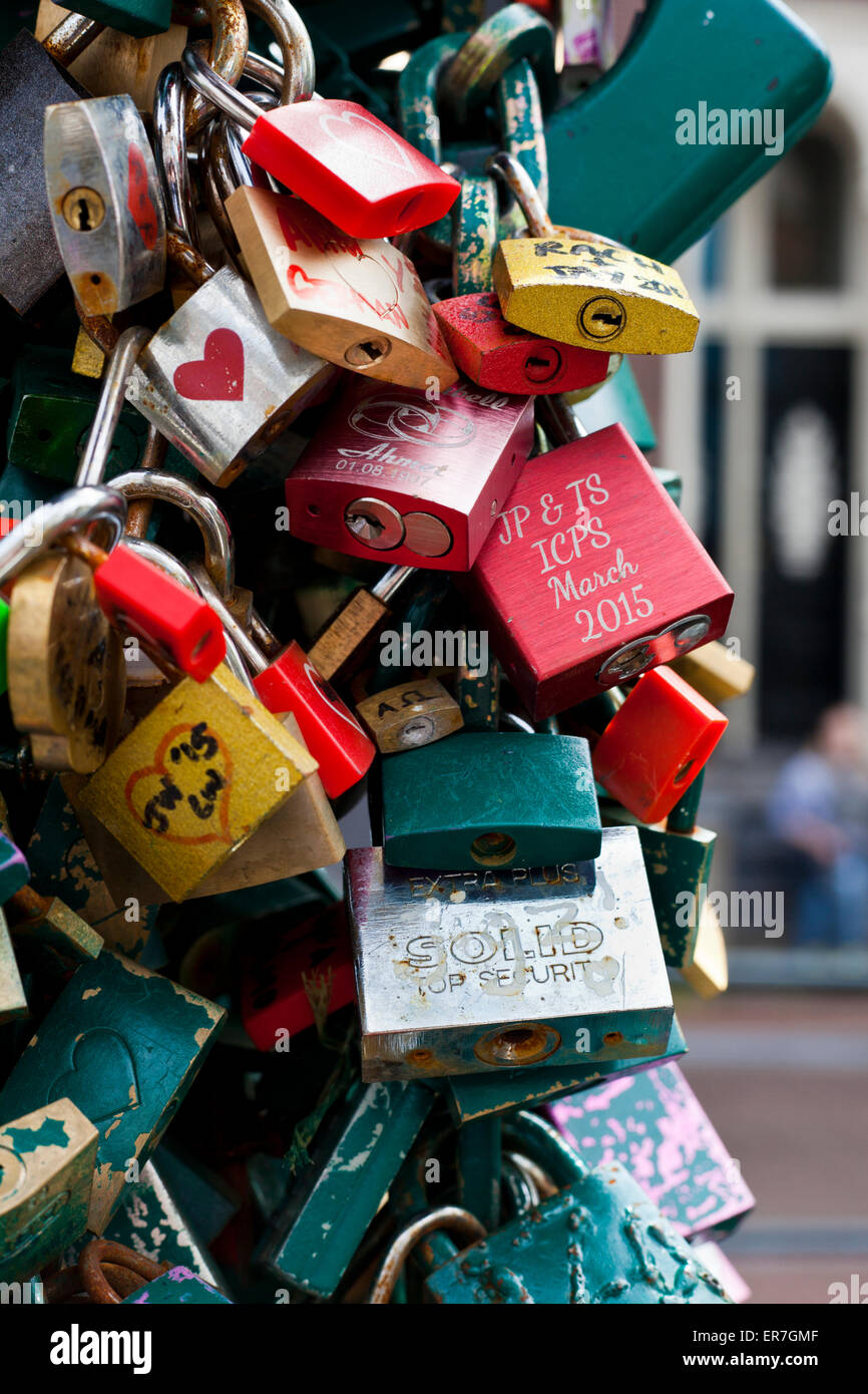 Love padlocks on the bridge over canal Kloveniersburgwal Amsterdam Holland The Netherlands Stock Photo