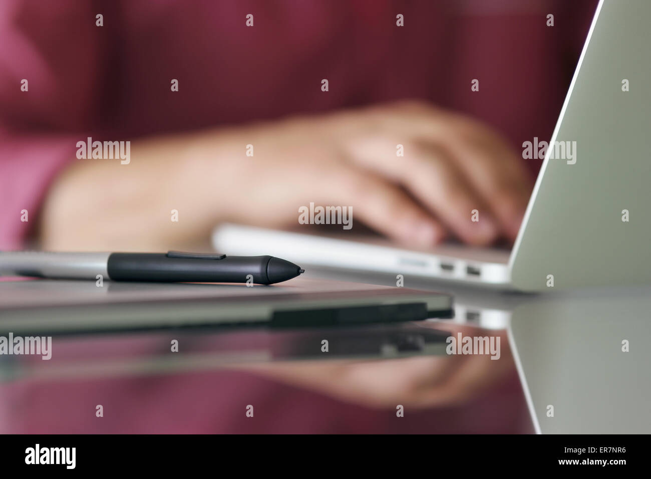 Photographer typing on keyboard of laptop computer. Closeup of digital