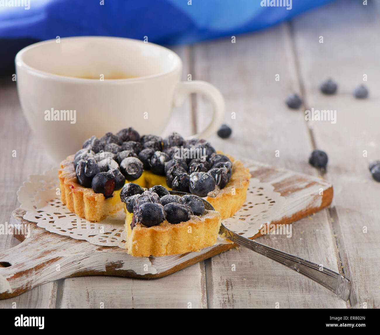 Berry tart and  cup of coffee on wooden table. Stock Photo