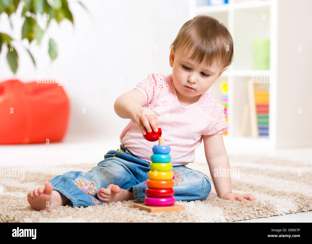 Child girl playing with toy indoors at home Stock Photo - Alamy