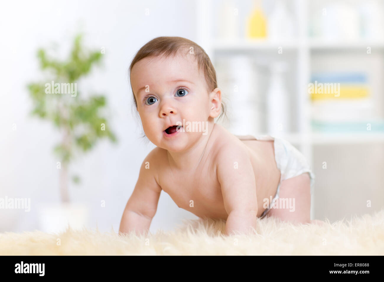 baby girl weared diaper crawling on floor at nursery Stock Photo Alamy