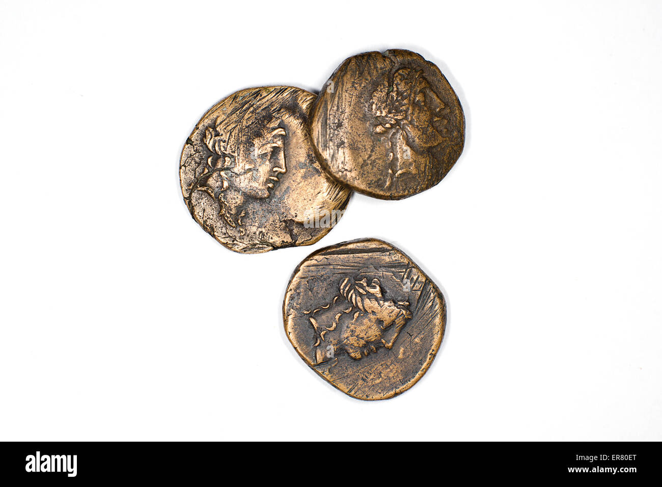 Old bronze coins with portraits of kings on a white background Stock Photo