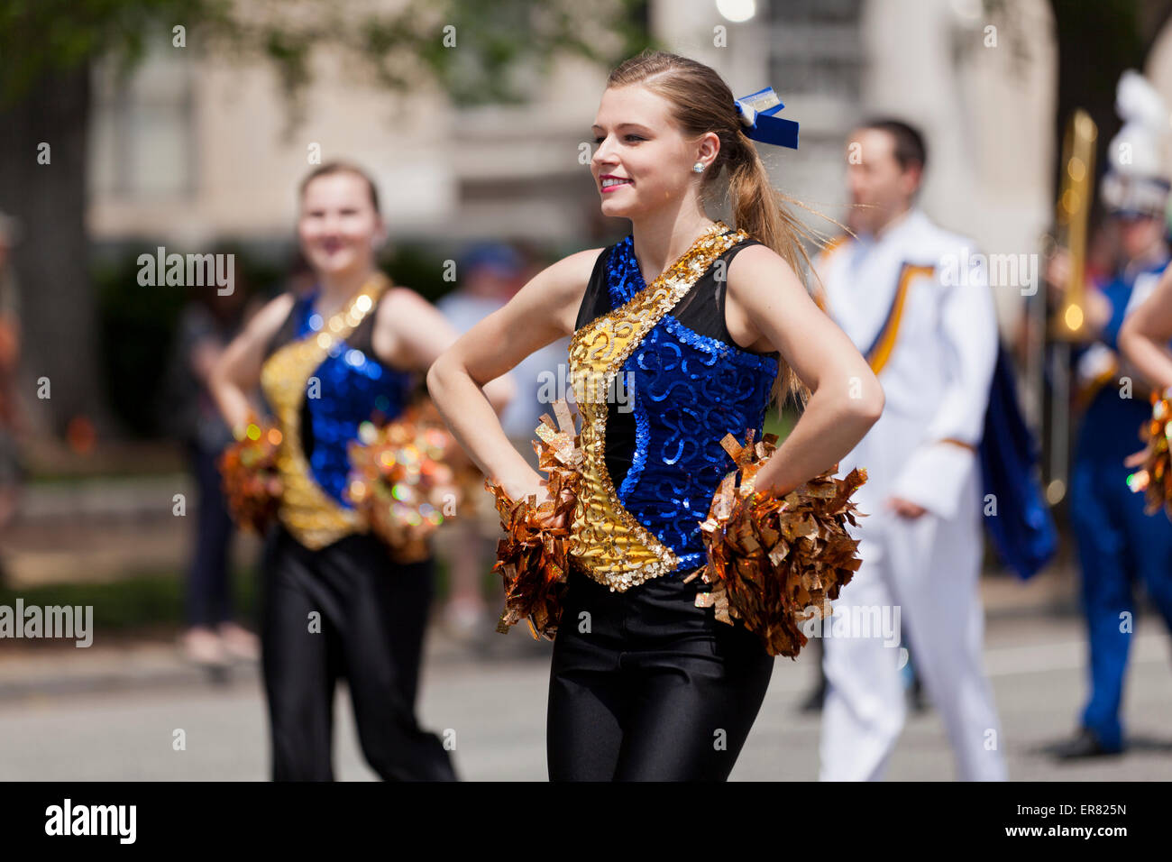 Young Caucasian high school cheerleaders in parade - USA Stock Photo