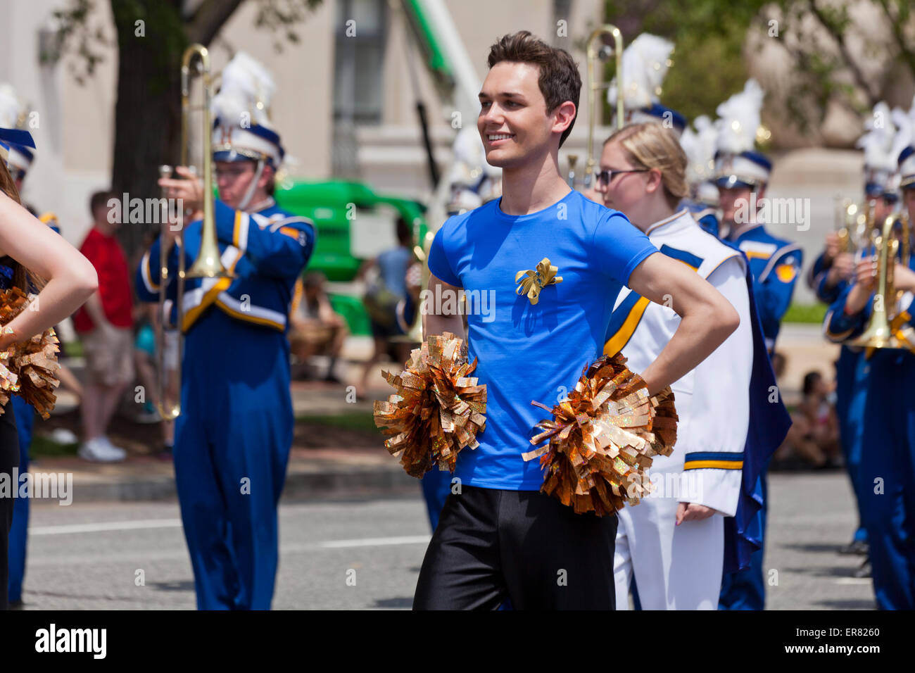 Young Caucasian male high school cheerleader in parade - USA Stock Photo