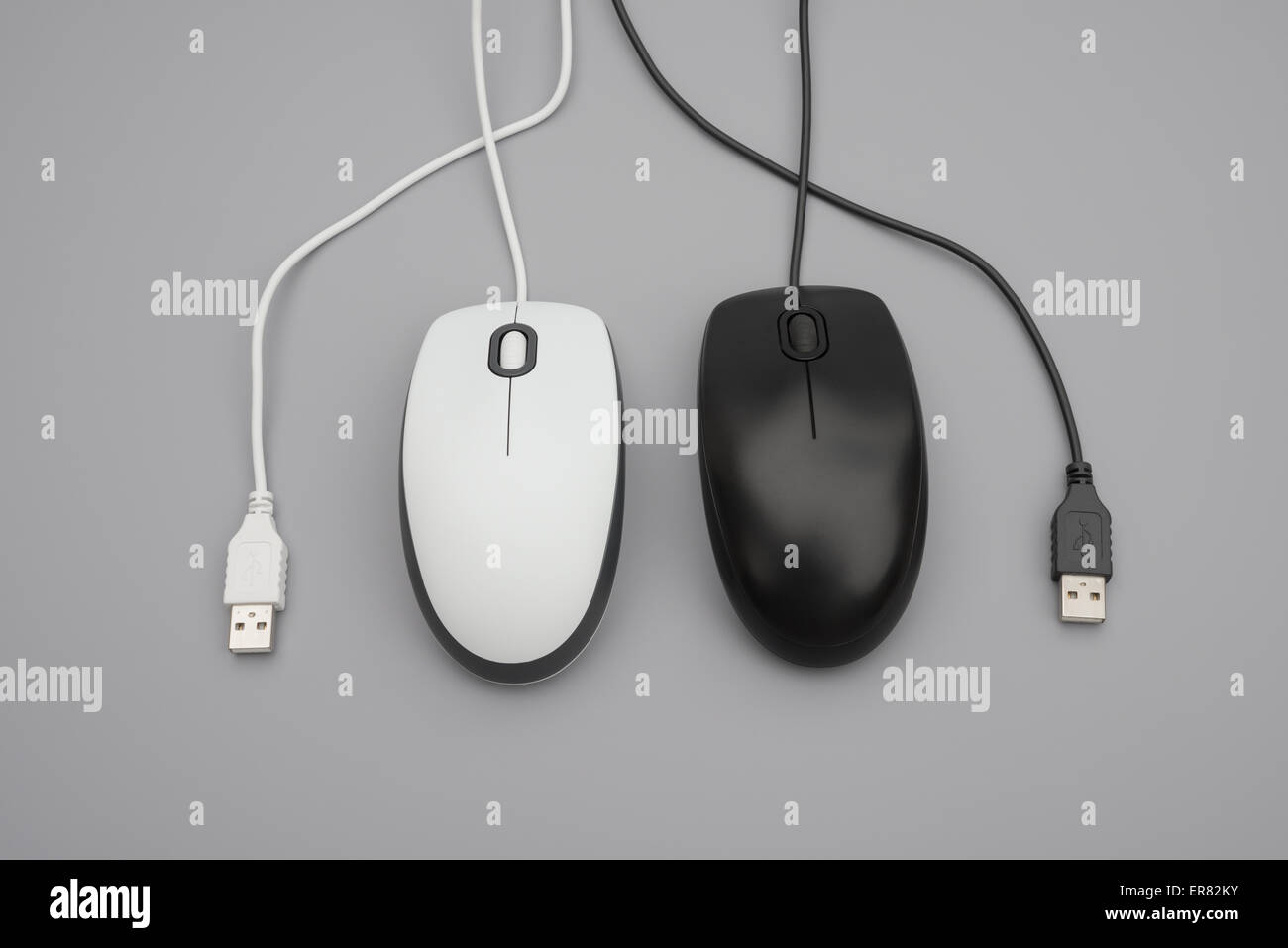 white and black mouses with cables twisted on grey background Stock ...