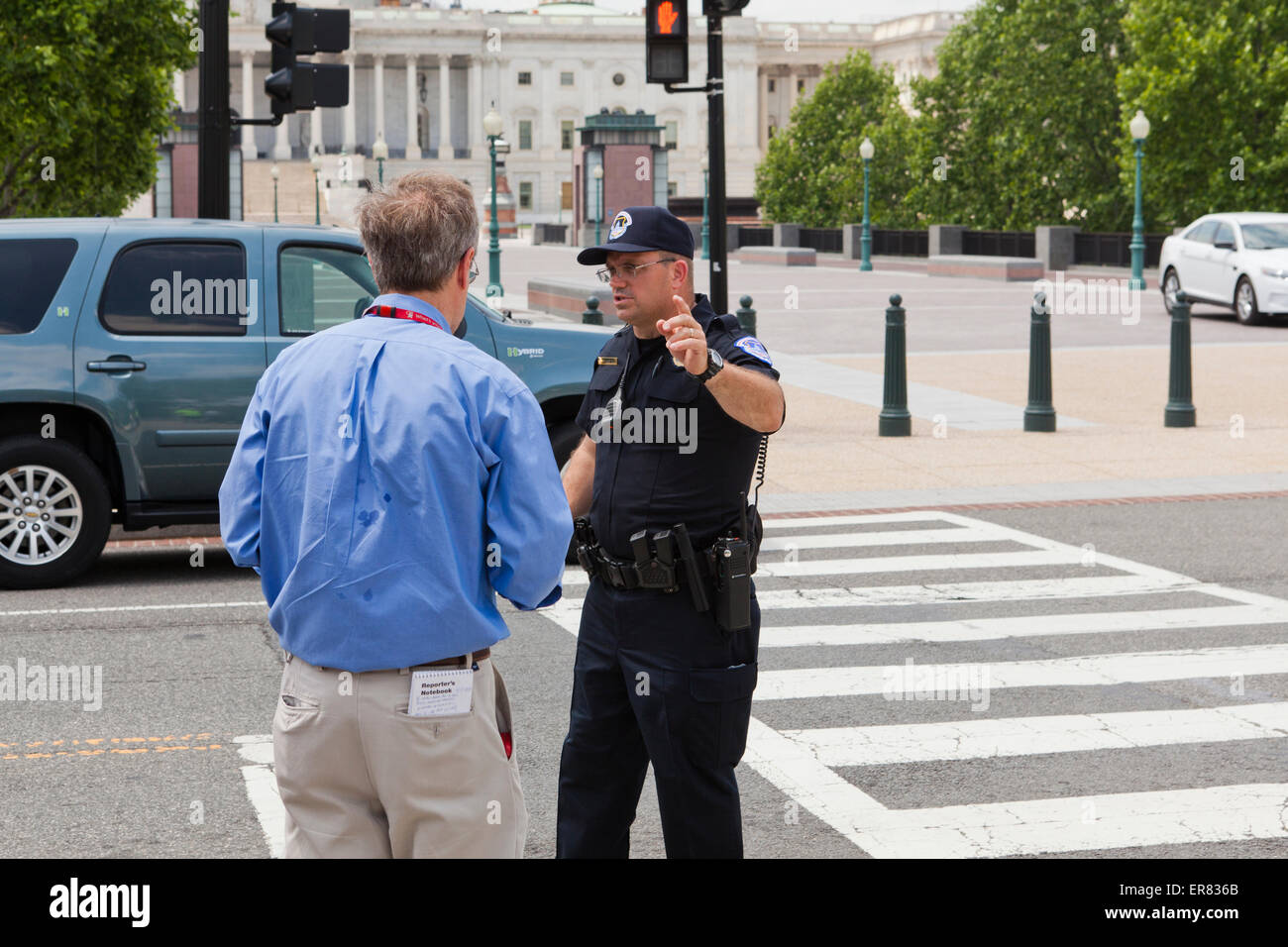 US Capitol policeman talking with reporter - Washington, DC USA Stock Photo
