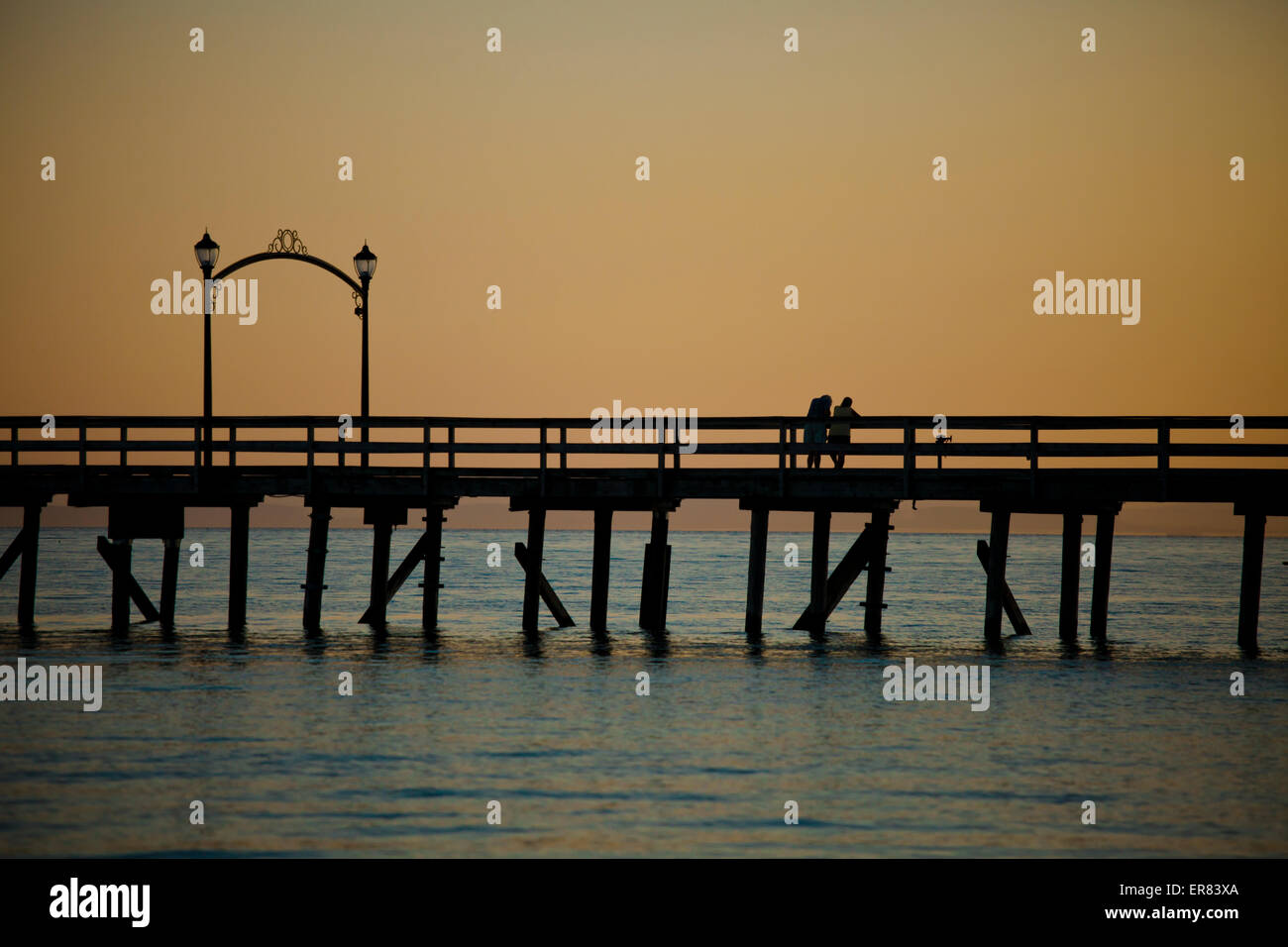 A couple on the pier after sunset in White Rock , British Columbia. Stock Photo