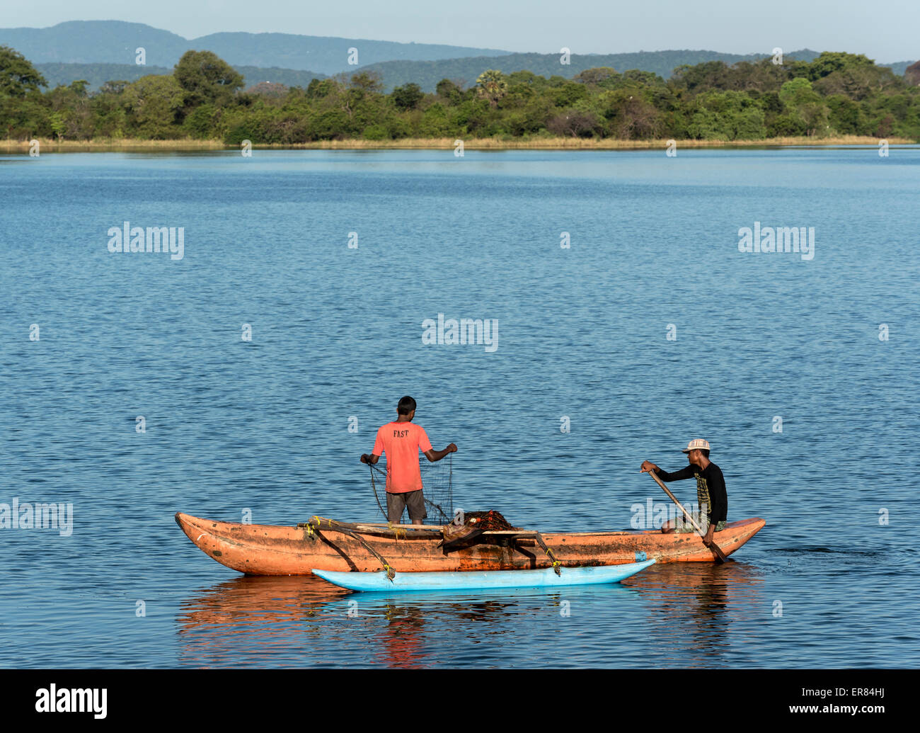 Men fishing from an outrigger canoe, in reservoir lake, Polonnaruwa,  Central Province, Sri Lanka, Asia Stock Photo - Alamy