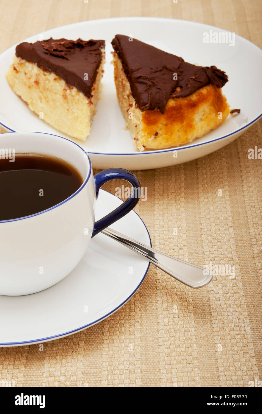 Close up of cup of black coffee and slice slices piece pieces of cake Stock Photo