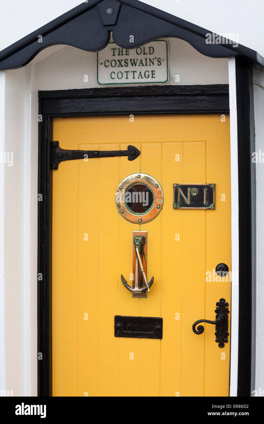 bright yellow front entrance door of The Old Coxswain's cottage No 1 at Weymouth in May Stock Photo
