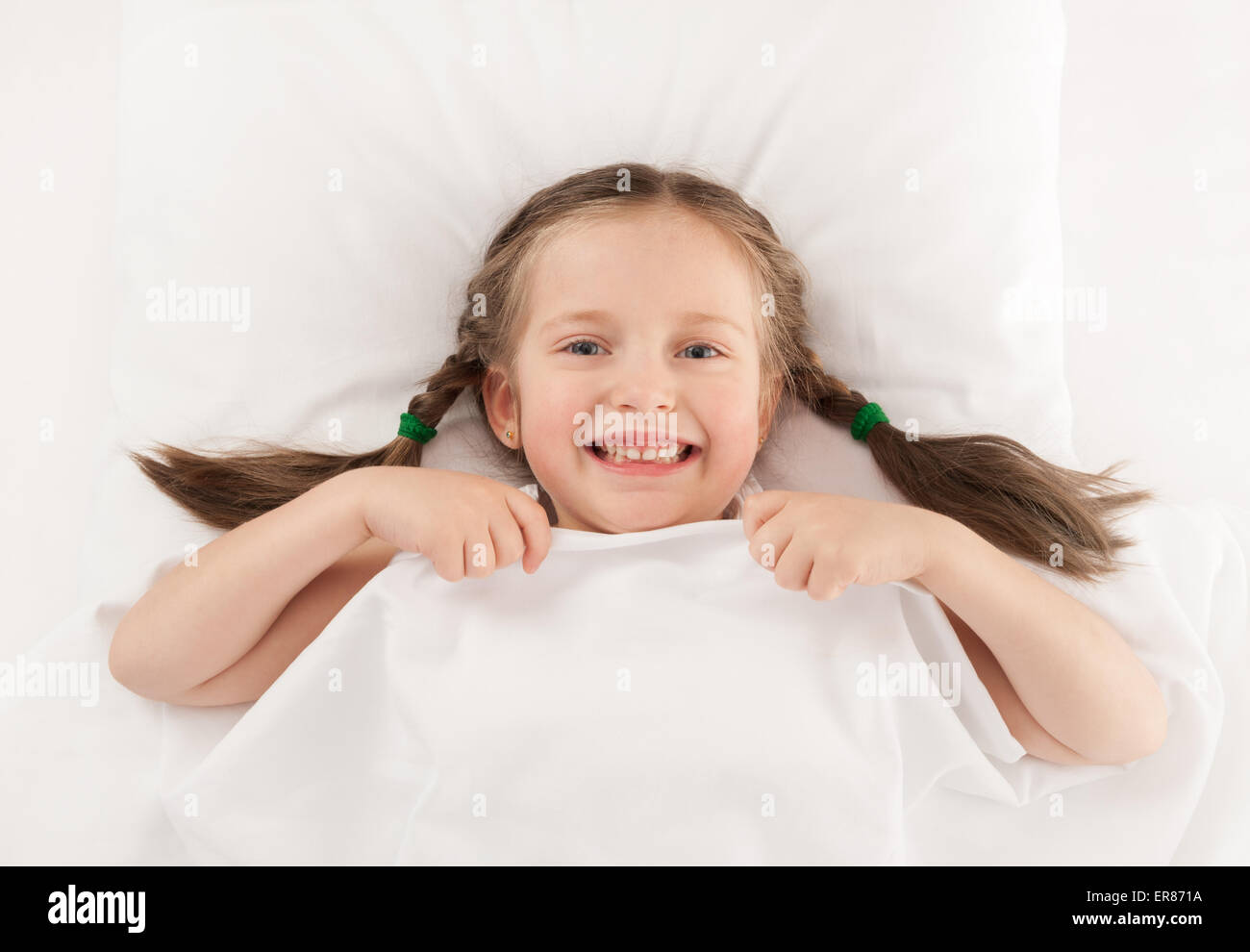 girl lying in bed on white Stock Photo