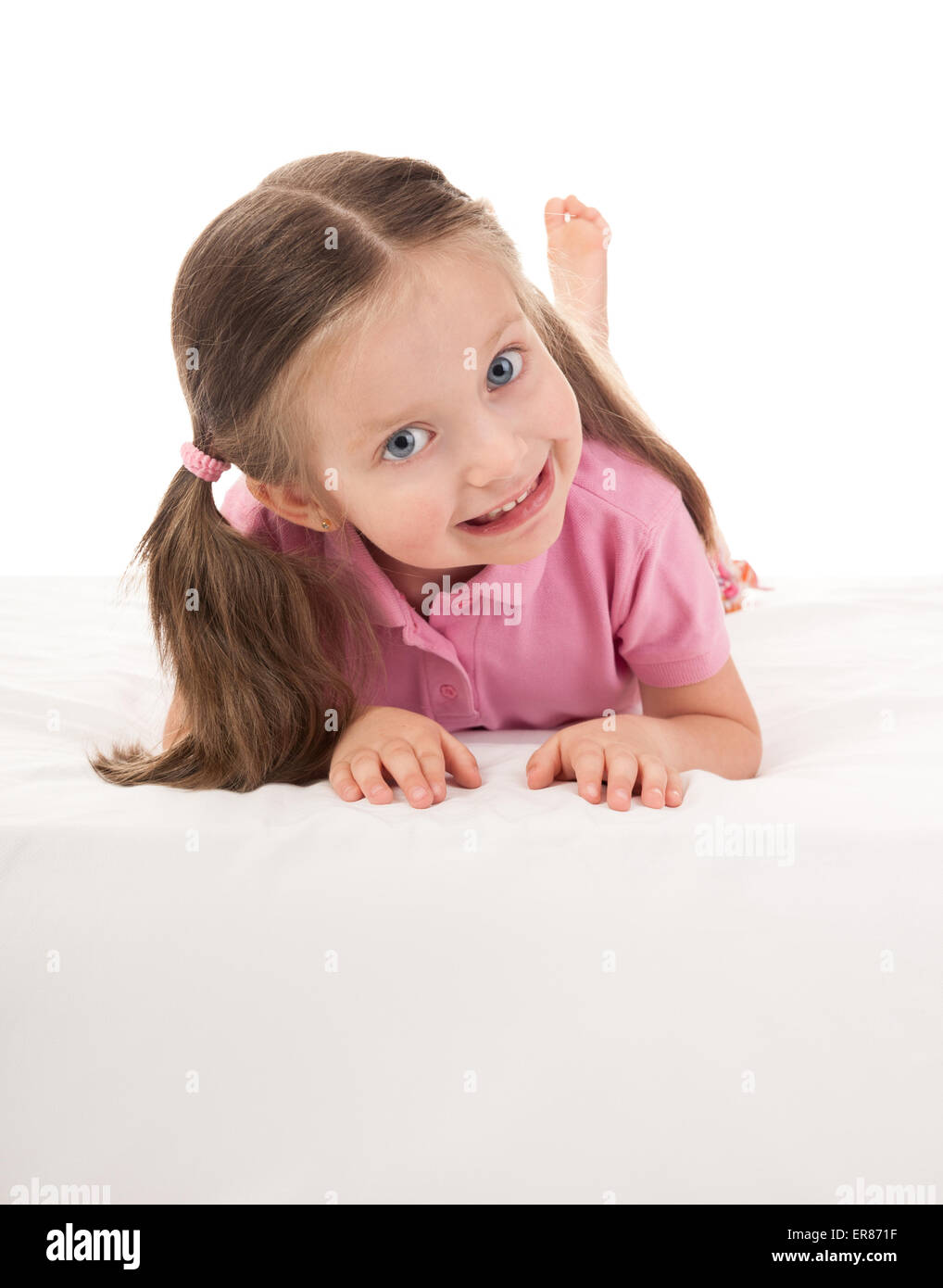 girl lying on stomach in bed on white Stock Photo Alamy