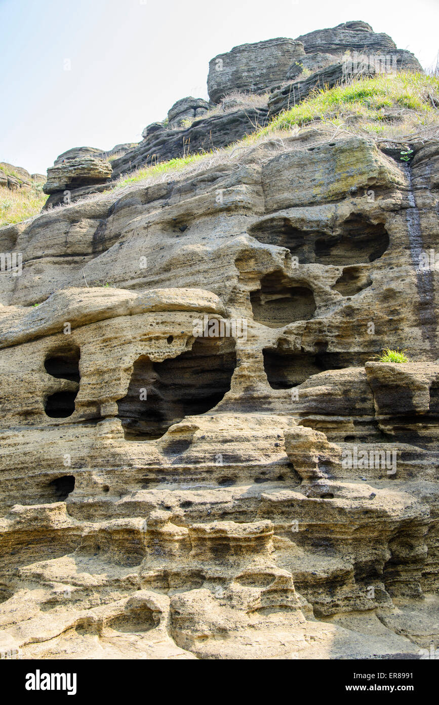 Multistory layered rough and strange sedimentary rocks in famous tourist site Yongmeori Coast(Dragon head coast) in Jeju Island. Stock Photo