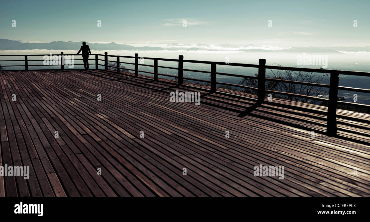 Mid distance of silhouette man looking at sea view from observation