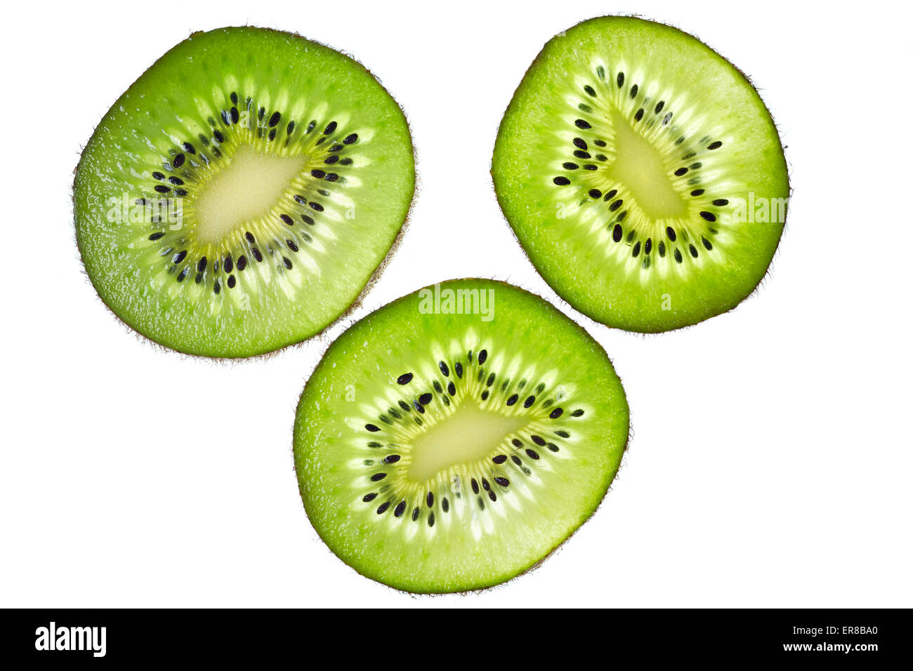 Close up of thin kiwifruit slices on white background. Stock Photo