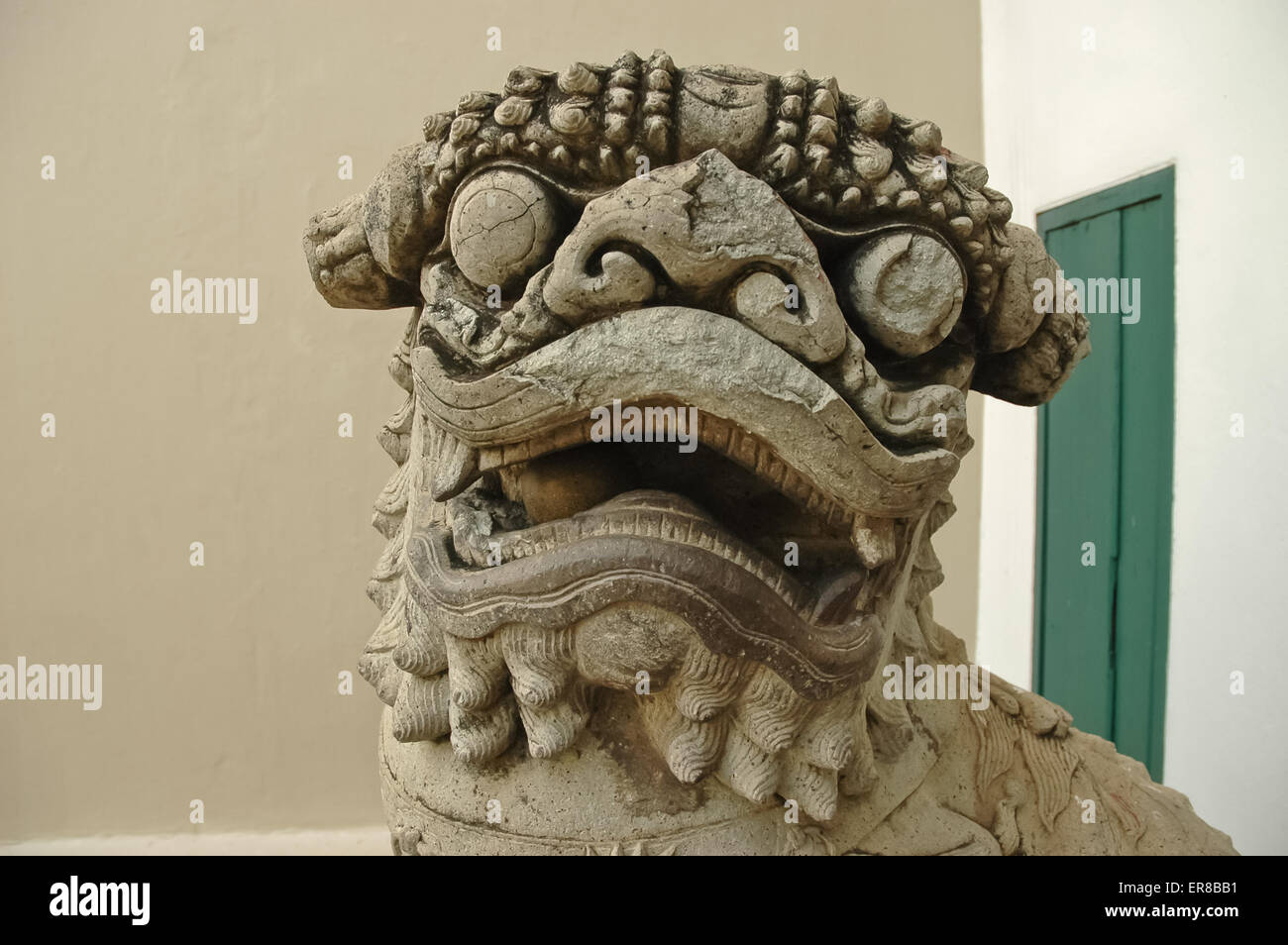 Ancient Chinese stone lion carved by hand Stock Photo