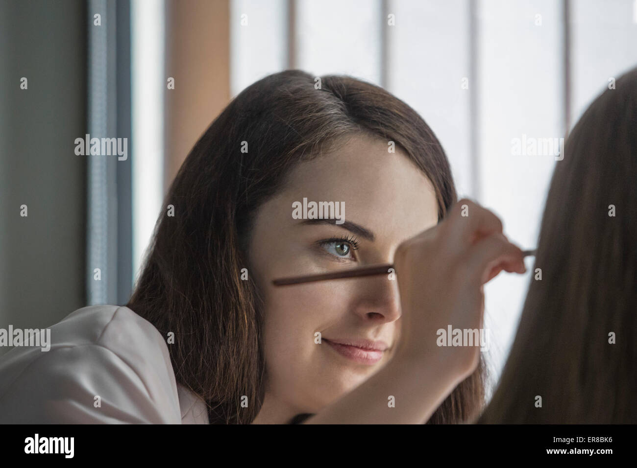 Woman applying make up pencil hi-res stock photography and images - Alamy
