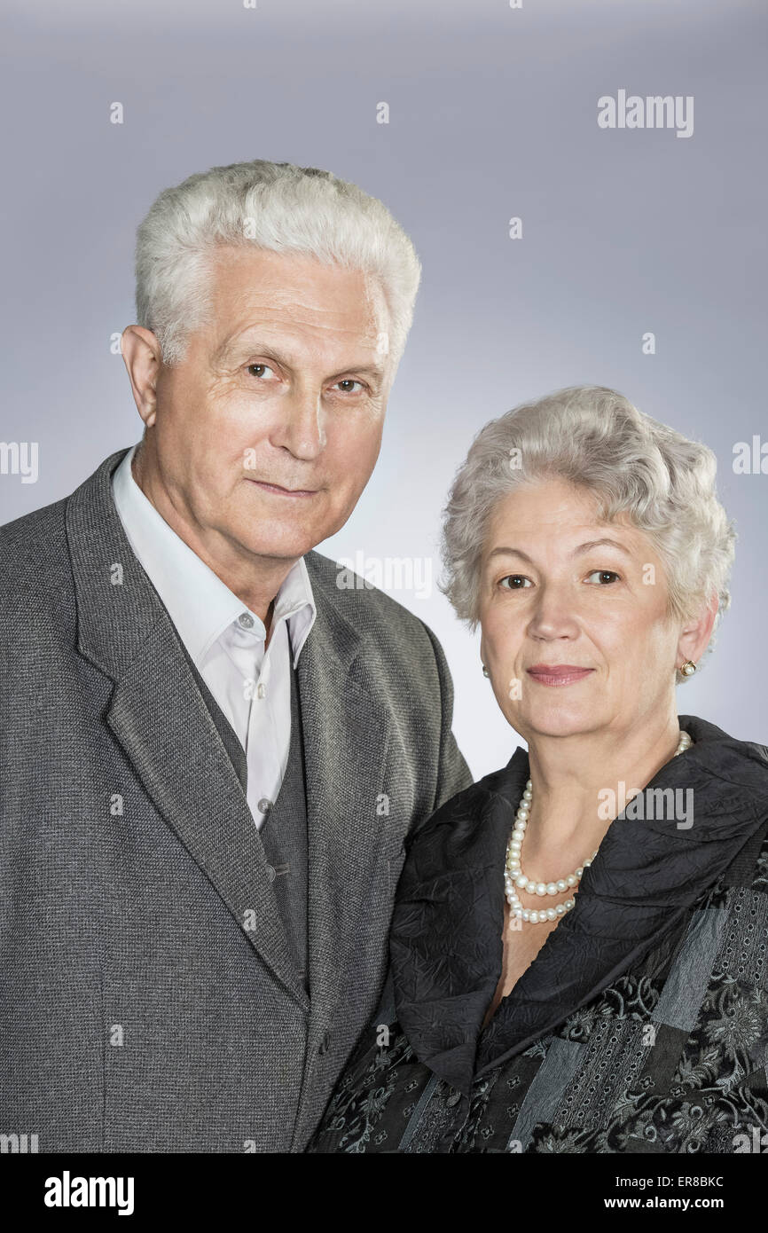 Portrait of senior couple against gray background Stock Photo