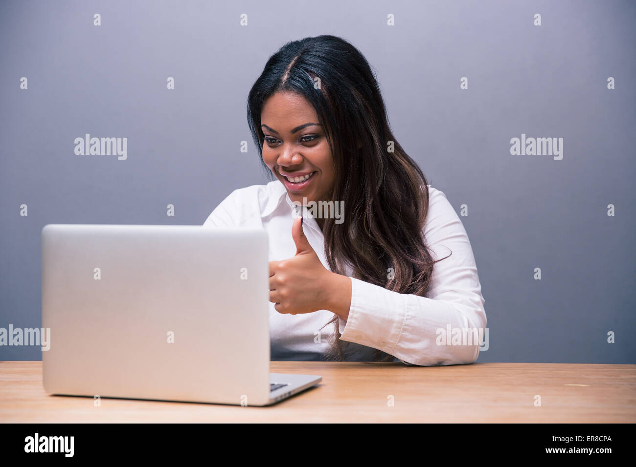 Happy african woman showing thumb hi-res stock photography and images ...