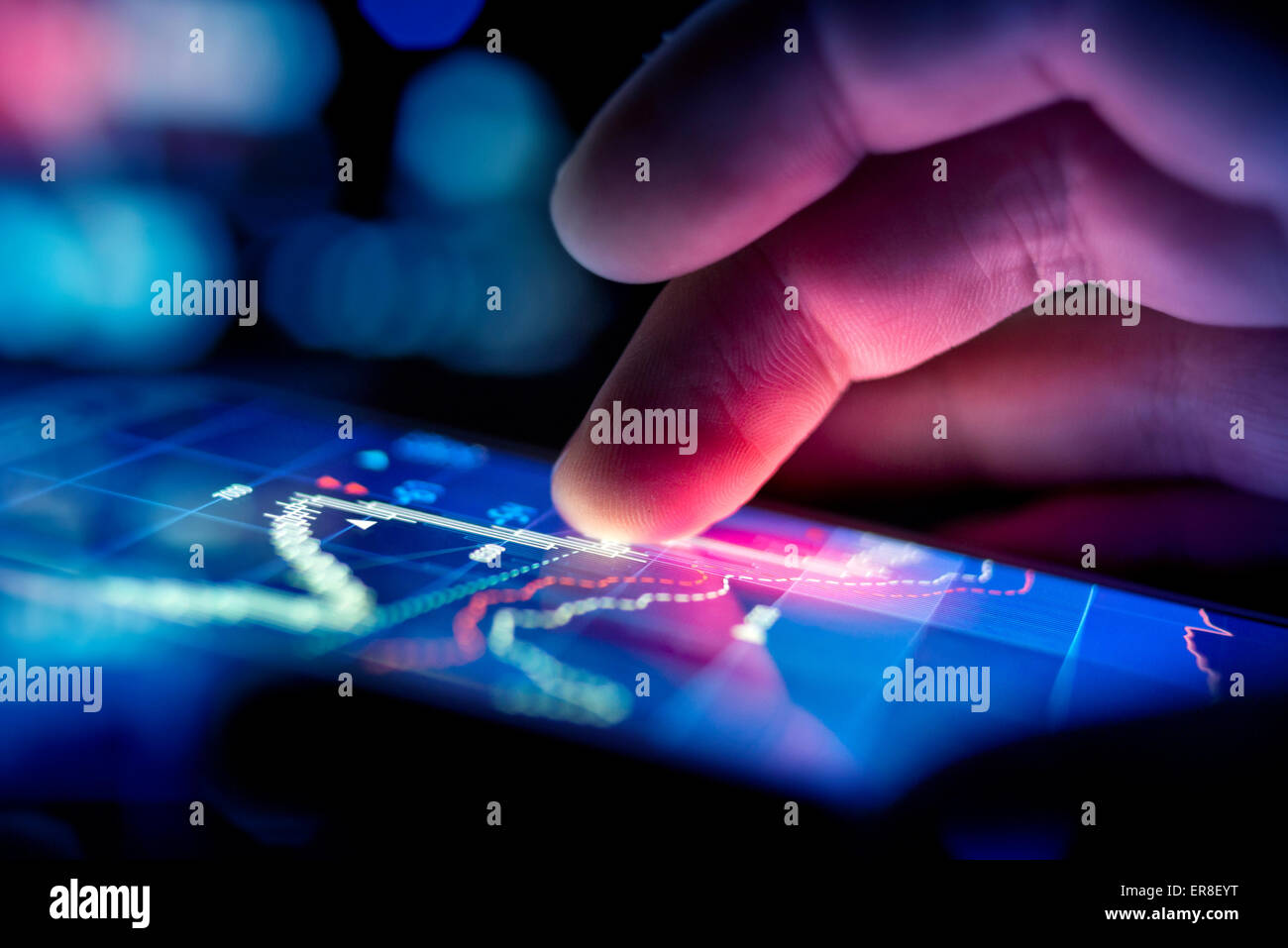 A city businessman using a mobile device to check stocks and market data. Close up shot. Stock Photo