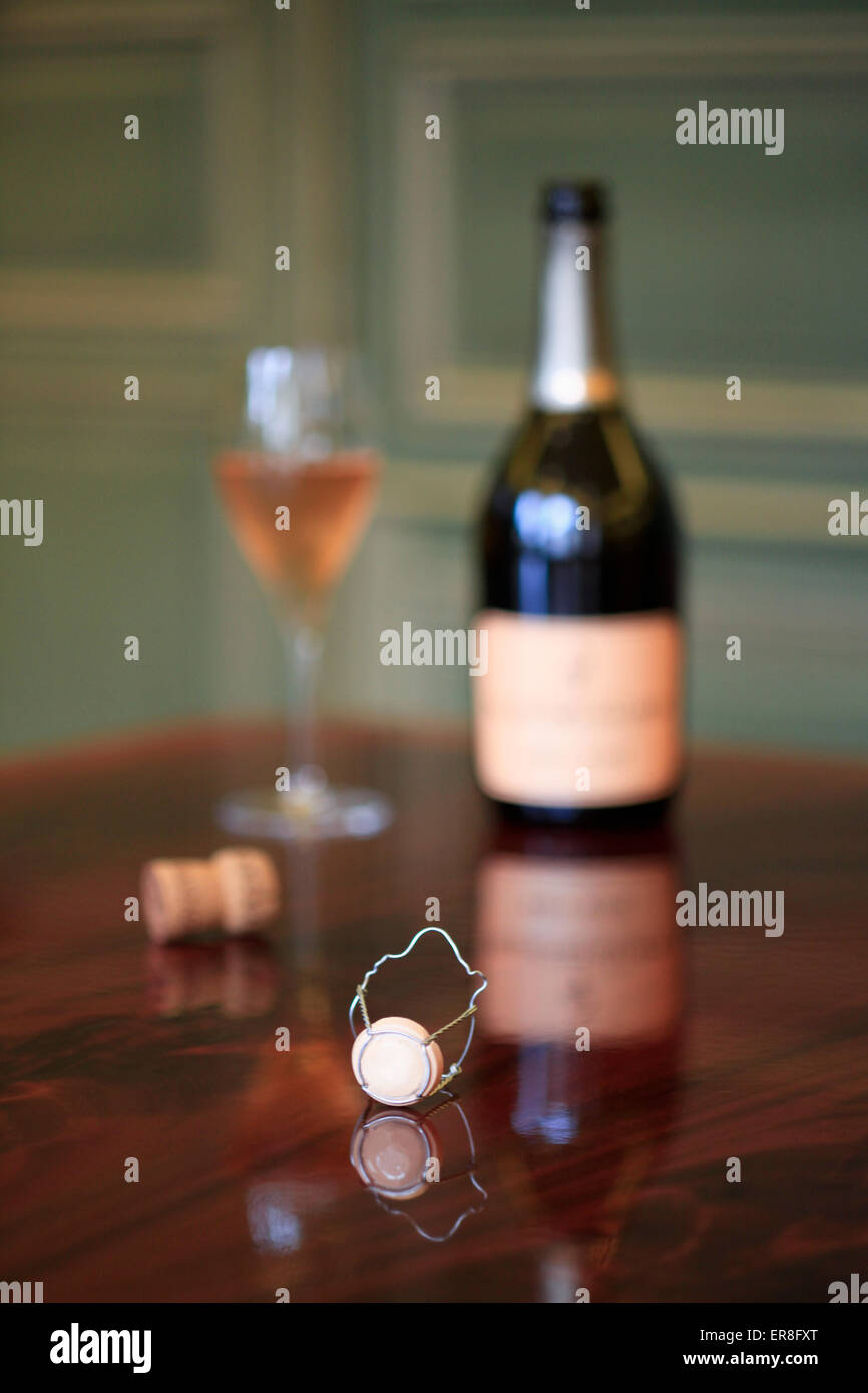 Wine bottle and glass on wooden table Stock Photo - Alamy