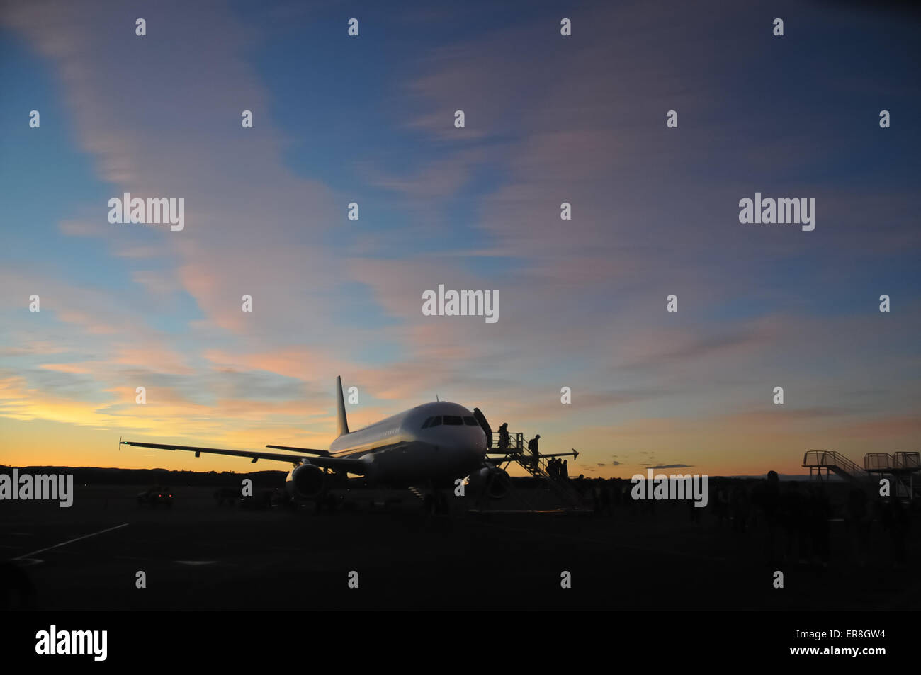 Airplane at the early morning with passengers Stock Photo