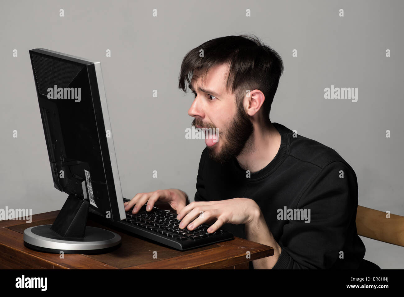 Funny and crazy man using a computer Stock Photo - Alamy
