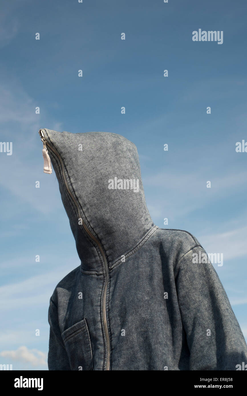 Low angle view of person covered with hood against sky Stock Photo
