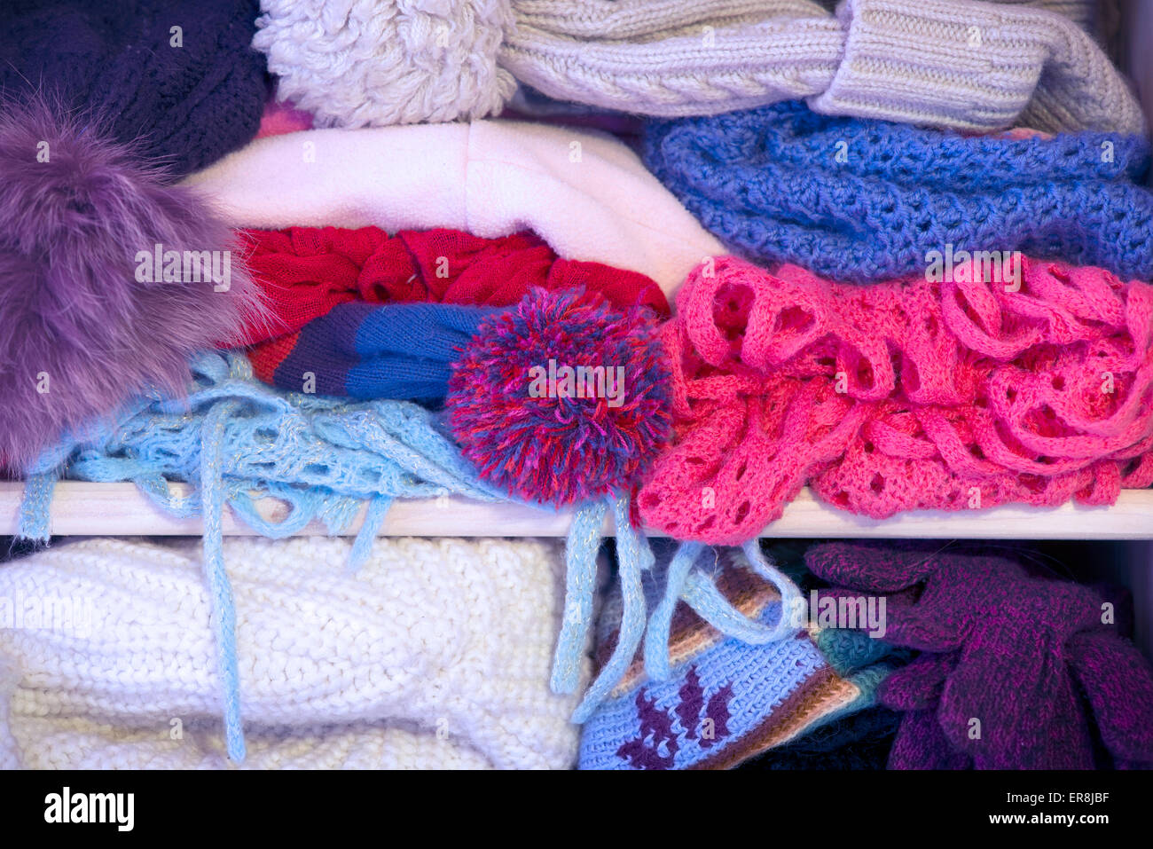 mixed warm clothes and accessories in wardrobe ready for winter weather Stock Photo