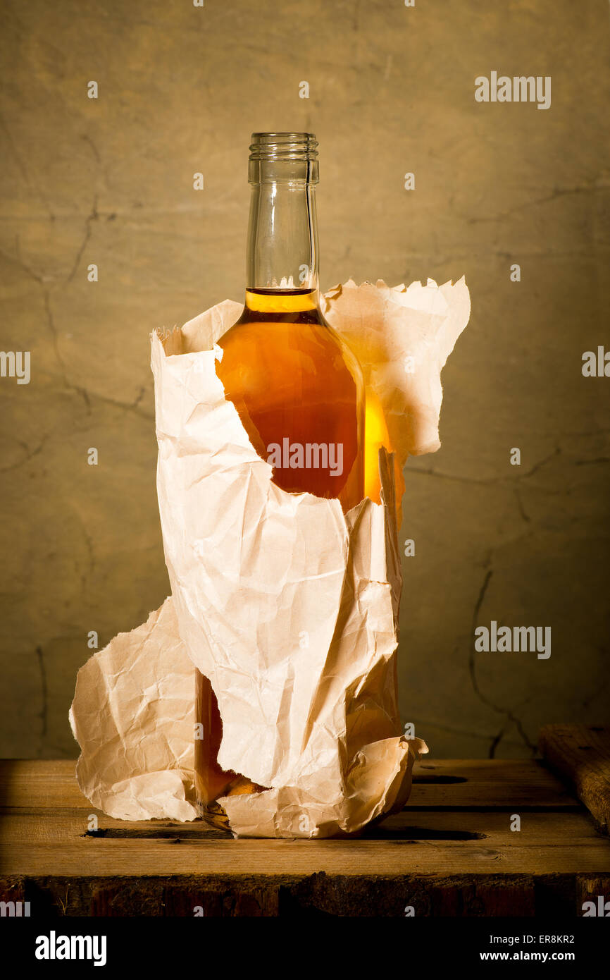 bottle of hard liquer in the paper bag Stock Photo