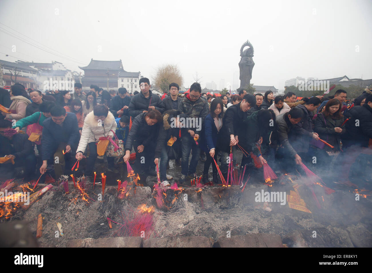 Feb 23, 2015-Wuhan, China- Chinese worshippers burn incenses to pray at the GuiyuanTemple in the hope that it brings them prospe Stock Photo