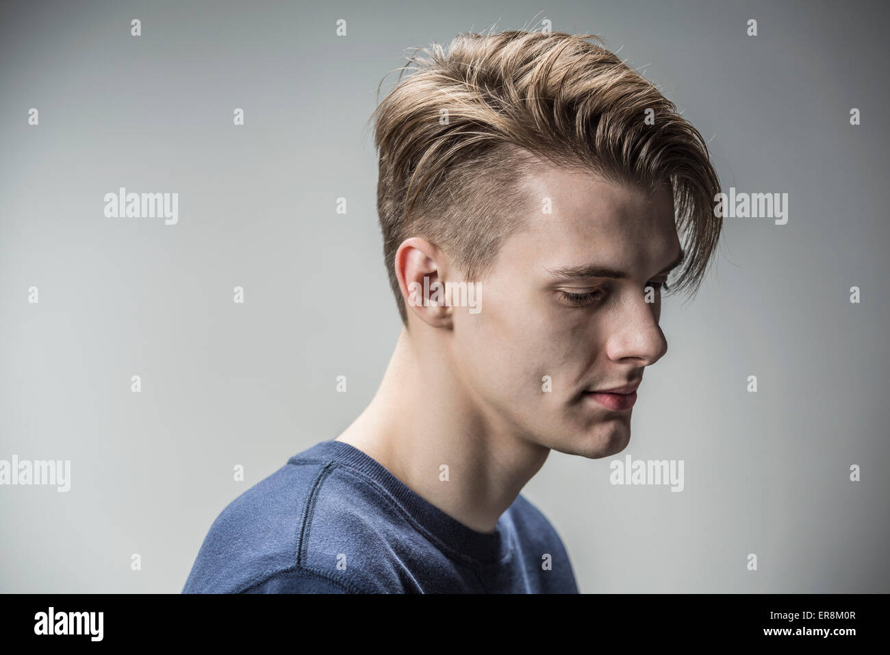 Sad young man against gray background Stock Photo