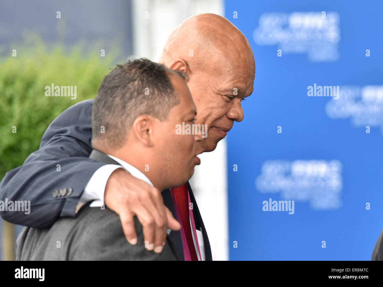 Zurich, Switzerland. 29th May, 2015. FIFA delegate Rignaal FRANCISCA (Curacao) puts his hand on the shoulder of a fellow FIFA delegate during his arrival at Zurich Hallenstadion for the 2015 FIFA congress. Credit:  thamerpic/Alamy Live News Stock Photo