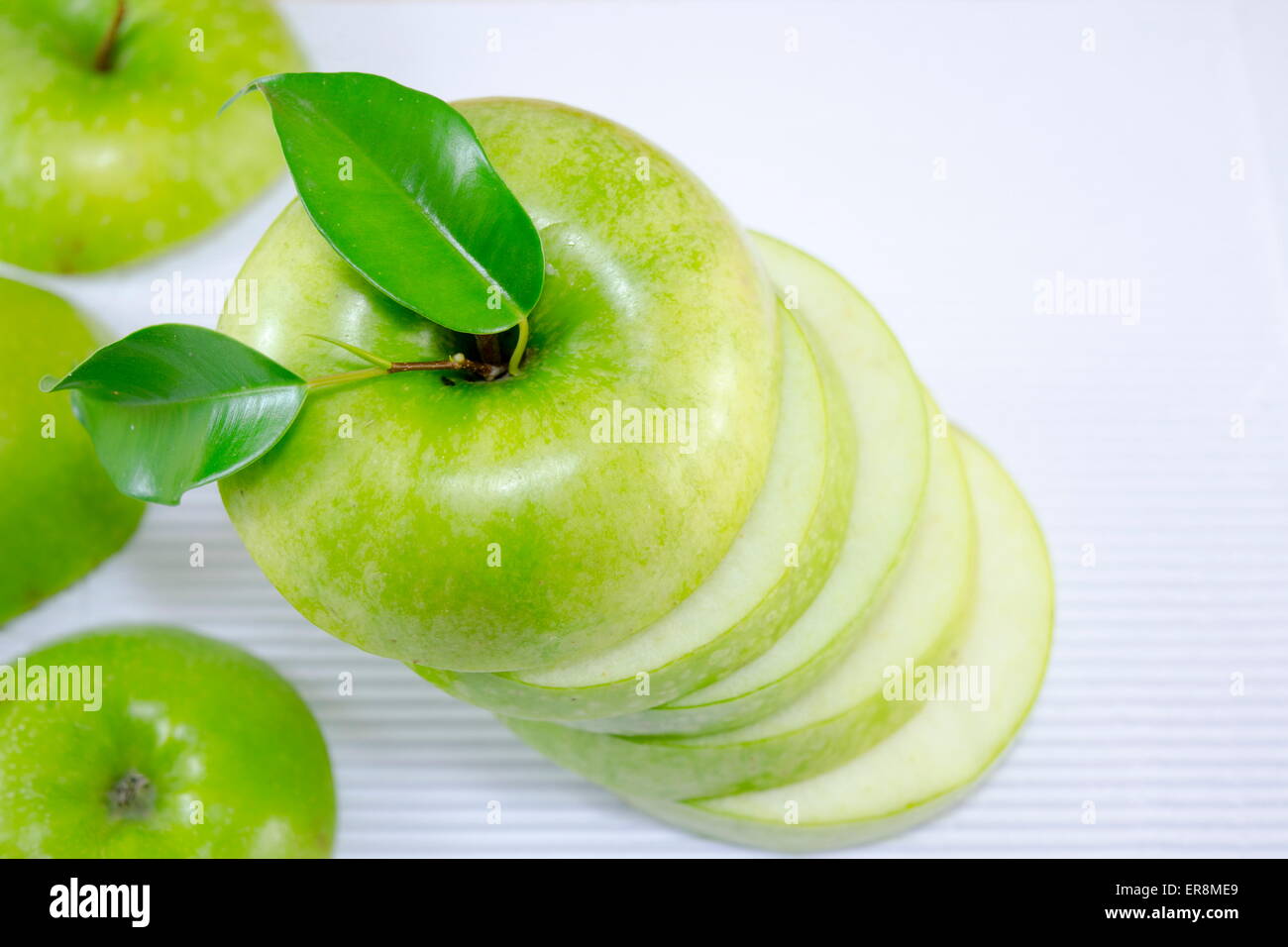 Apple sliced in thin pieces on white Stock Photo