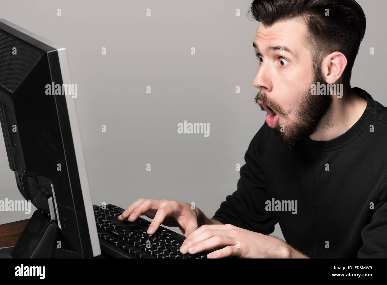 Funny and crazy man using a computer Stock Photo - Alamy