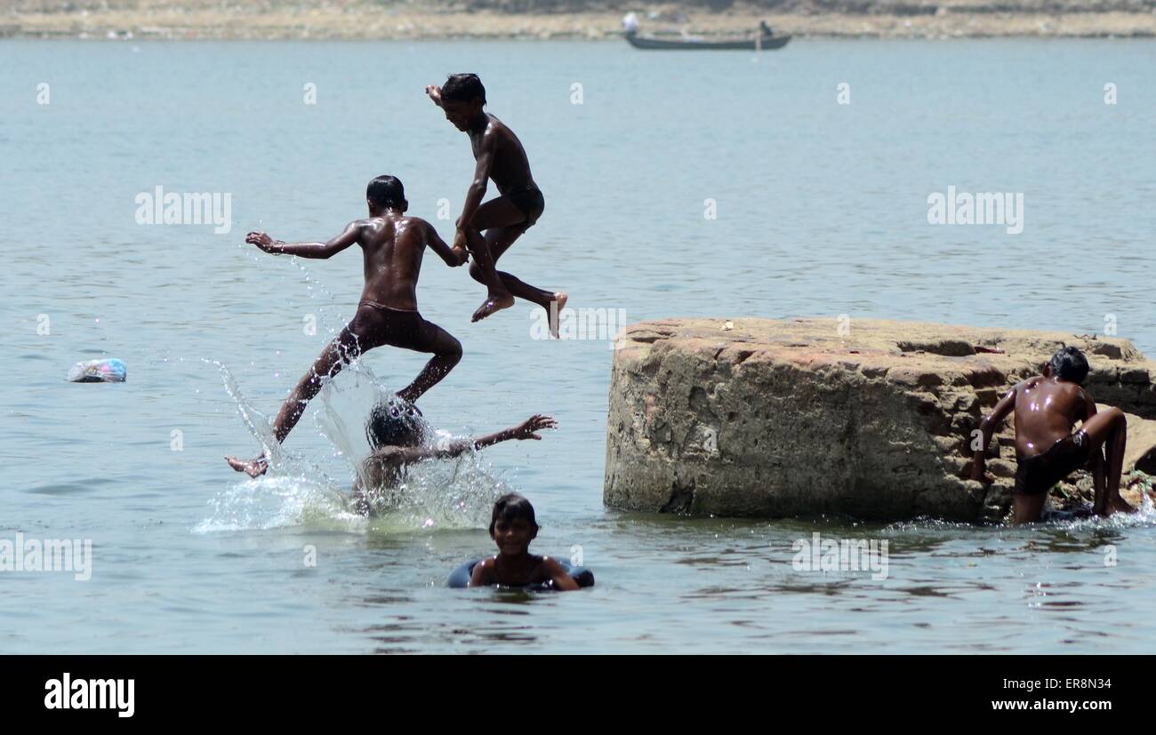 Allahabad, India. 29th May, 2015. Indian boys swimming in River Yamuna to cool off during a hot day in Allahabad. At least 1,300 people died in the neighboring state of Andhra Pradesh, along with 12 in Odisha, taking the national toll from this heat wave to more than 1,700. Credit:  Prabhat Kumar Verma/Pacific Press/Alamy Live News Stock Photo