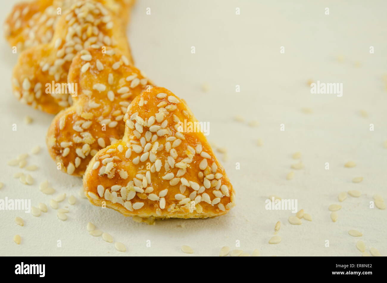 Salty heart shaped sesame crackers Stock Photo