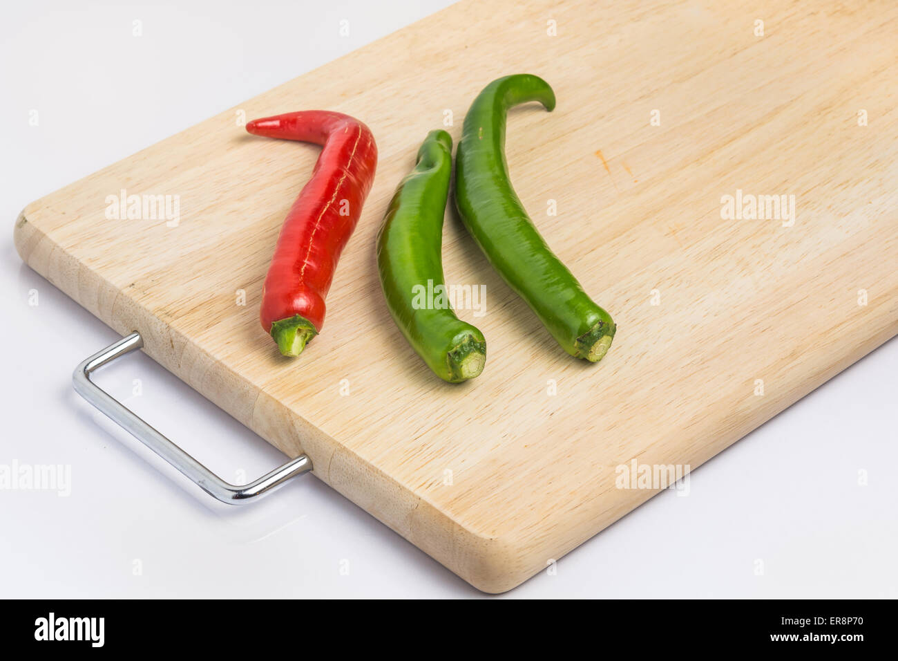 Fresh peppers on the chopping block preparation cooking Stock Photo Alamy
