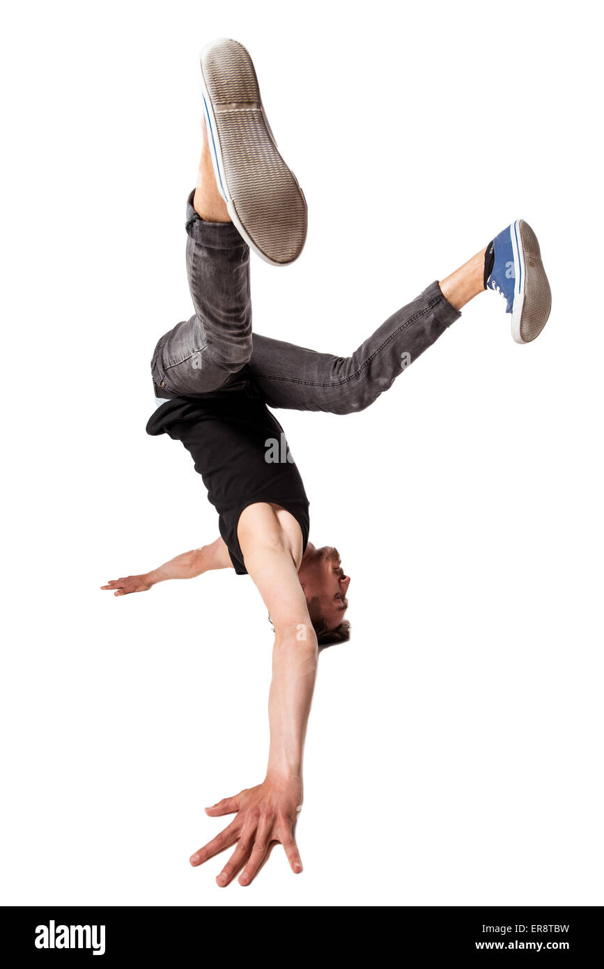 Break dancer doing one handed handstand against a white background Stock Photo