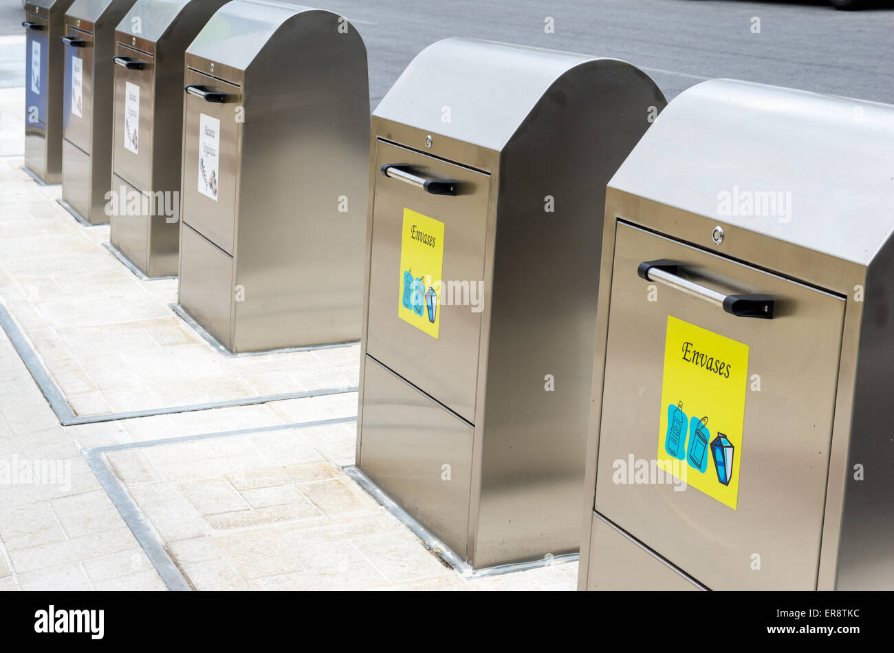 Newly sited environmental recycling containers on a pavement or sidewalk in Spain Europe. Stock Photo