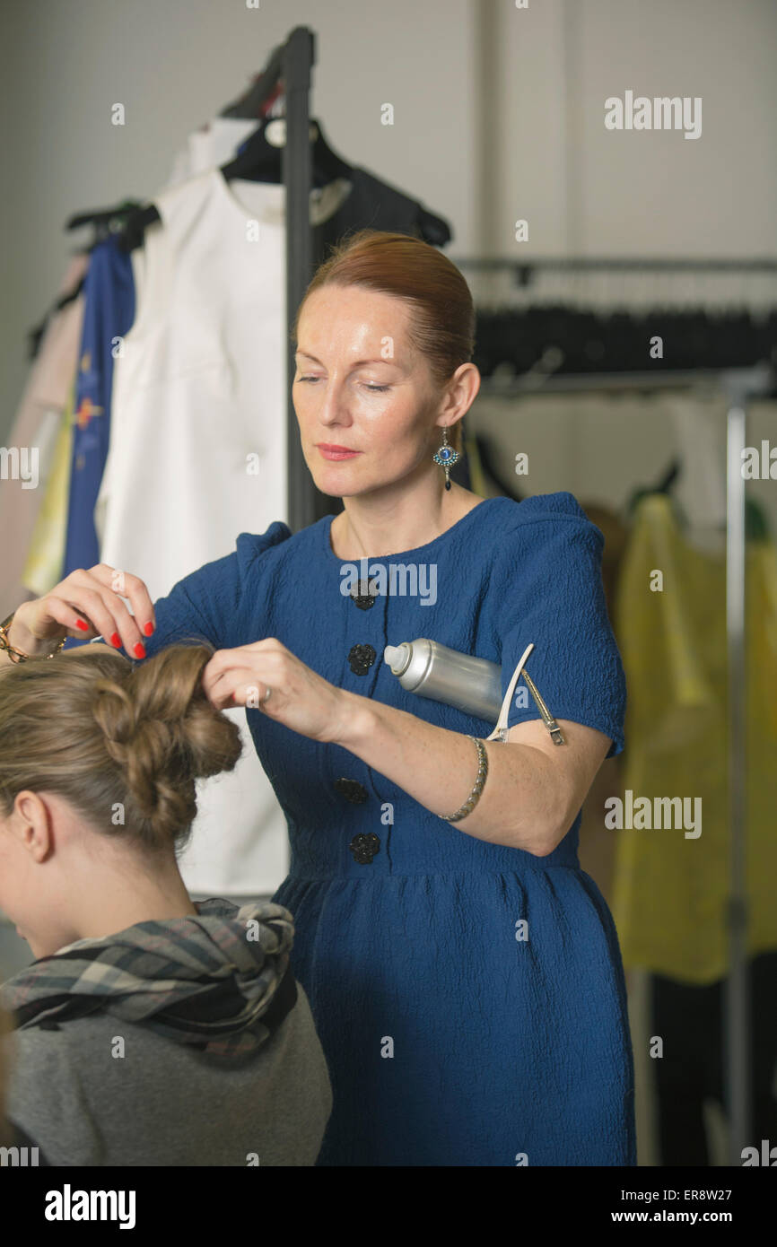 Hairdresser making model's hair in studio Stock Photo