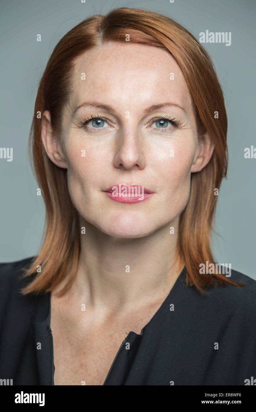 Portrait of confident mature woman against gray background Stock Photo