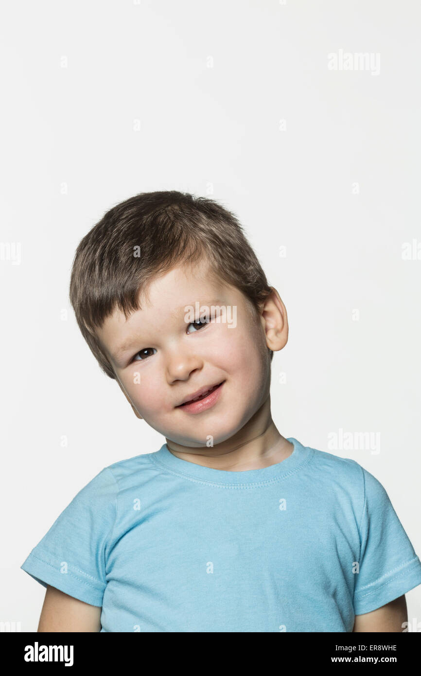 Portrait of cute boy against white background Stock Photo