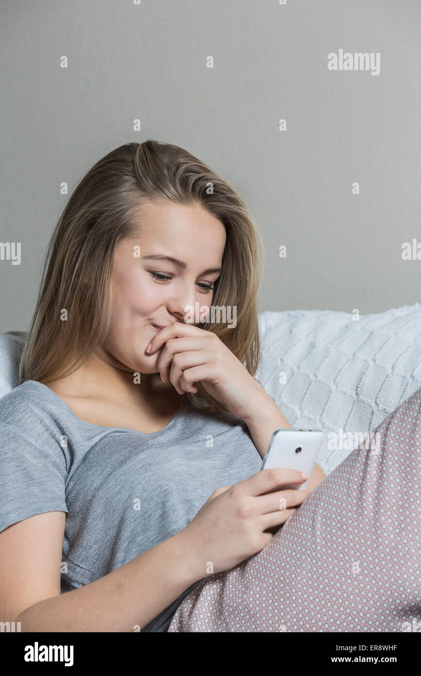 Teenage girl sitting sofa hi-res stock photography and images - Alamy