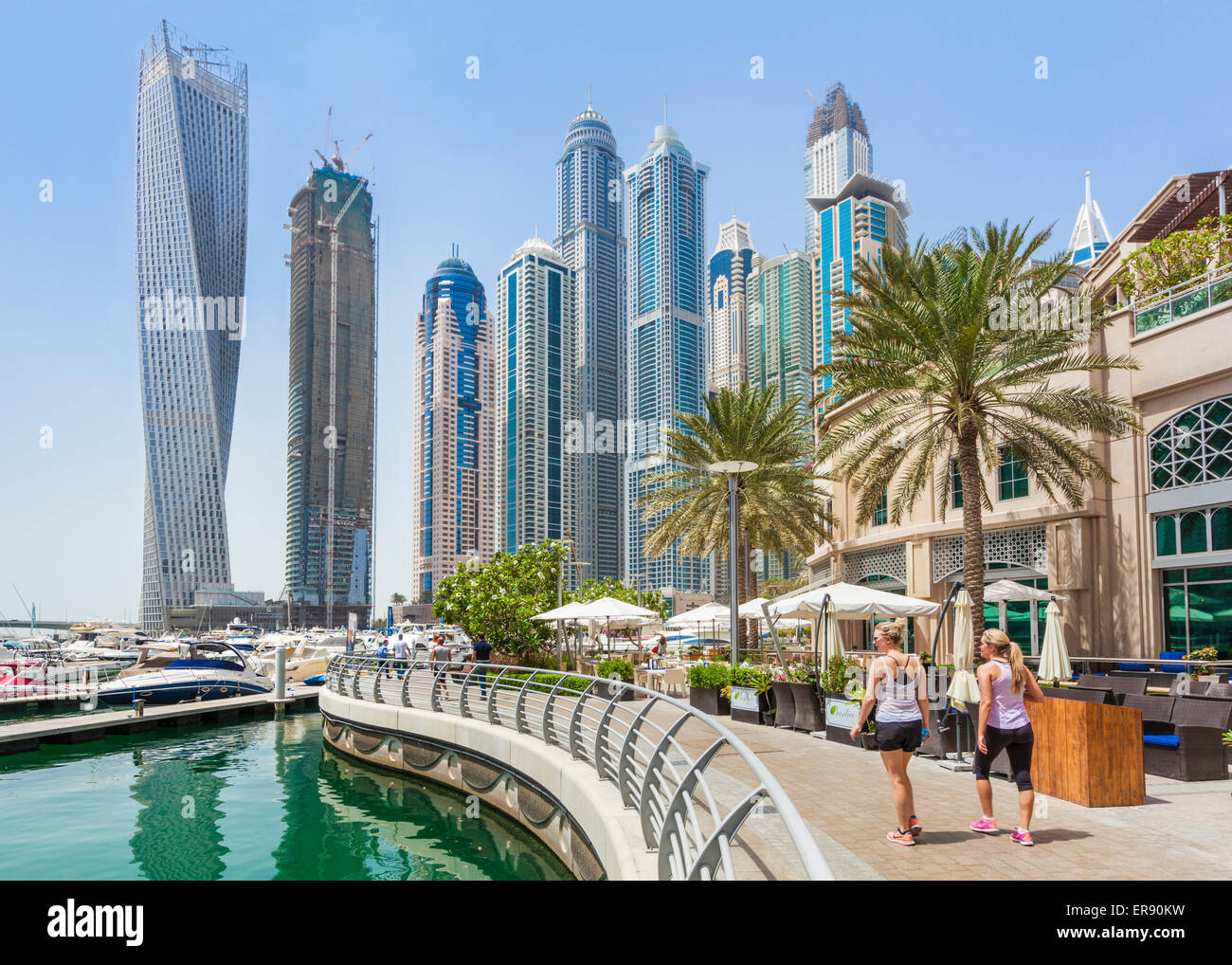 Dubai Marina Skyscrapers with two female runners Dubai City United Arab Emirates UAE Middle east Stock Photo