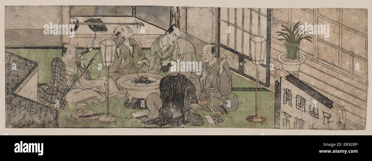 Five men relaxing around a hibachi Stock Photo