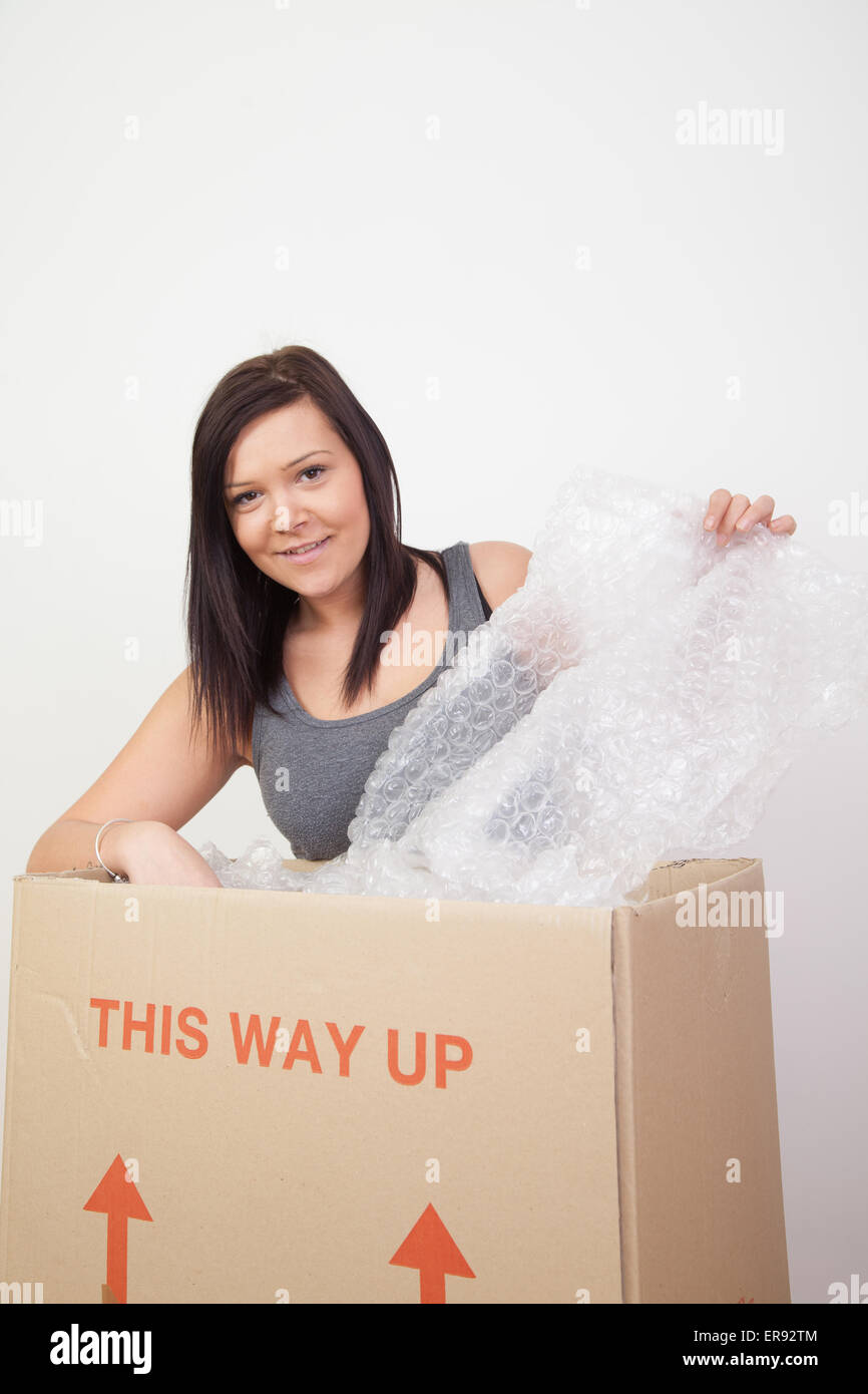 Woman preparing to pack / unpack move house. Stock Photo