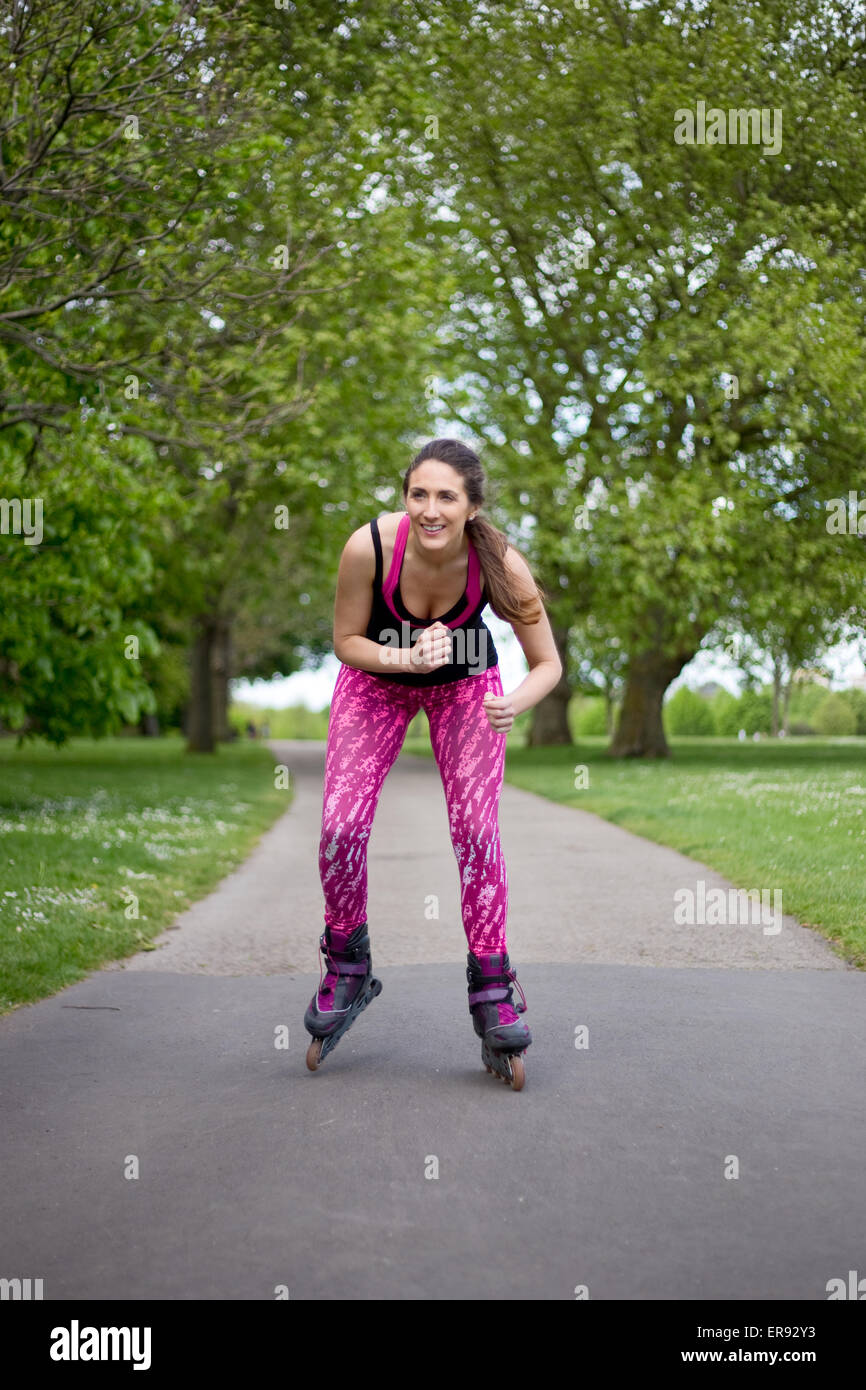 young woman rollerblading in the park Stock Photo